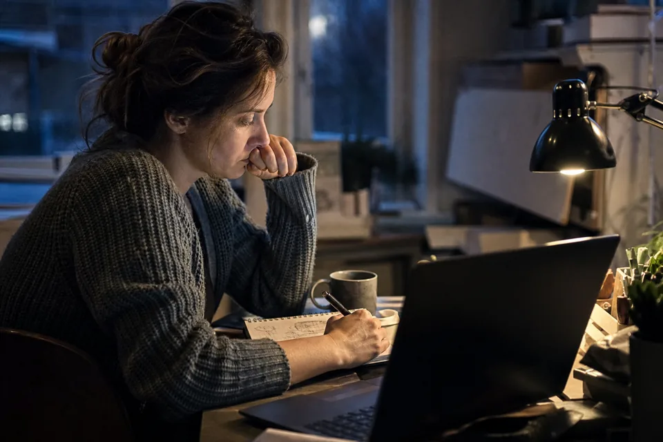 Developer at night checking a payment event log on two monitors
