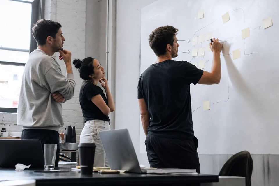 Growth team planning a campaign at a whiteboard